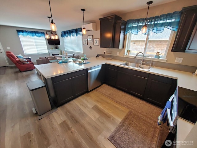 801 340th Pl, Ocean Park, WA 98640 - kitchen with stainless steel dishwasher, light wood-style floors, range, and a sink