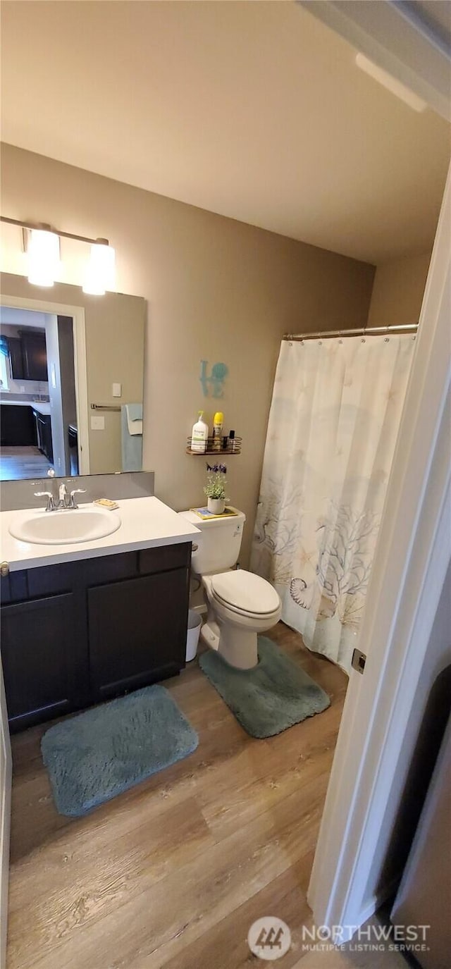 801 340th Pl, Ocean Park, WA 98640 - bathroom featuring a shower with shower curtain, vanity, toilet, and wood finished floors