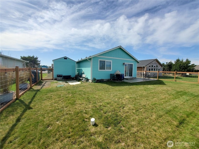 801 340th Pl, Ocean Park, WA 98640 - back of property featuring a patio, a yard, and a fenced backyard