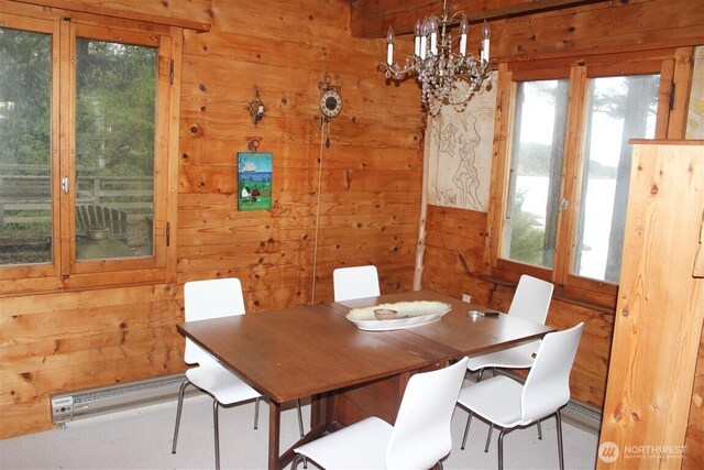 23 Brown Is, Brown Island, WA 98250 - dining space with wooden walls, plenty of natural light, and a chandelier