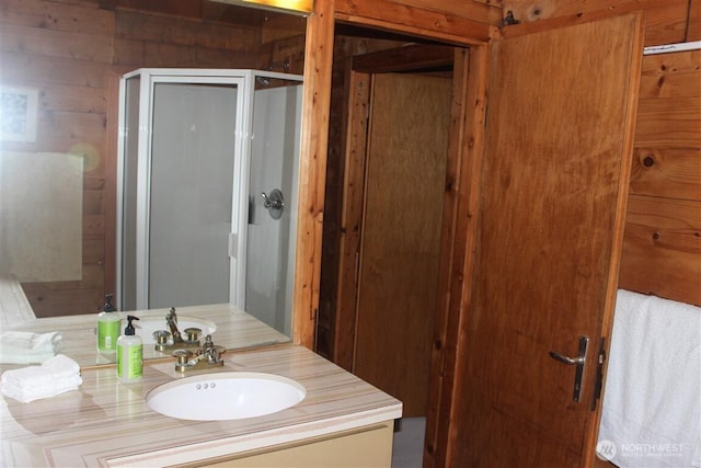 23 Brown Is, Brown Island, WA 98250 - bathroom featuring vanity, wooden walls, and a stall shower
