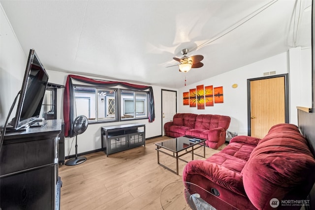 living room with lofted ceiling, wood finished floors, and a ceiling fan