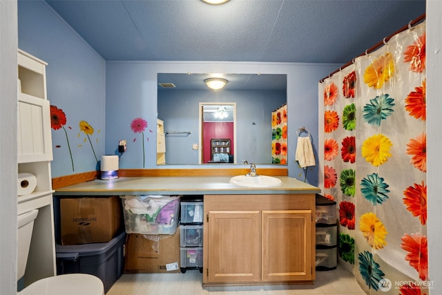 bathroom featuring vanity, a textured ceiling, and curtained shower