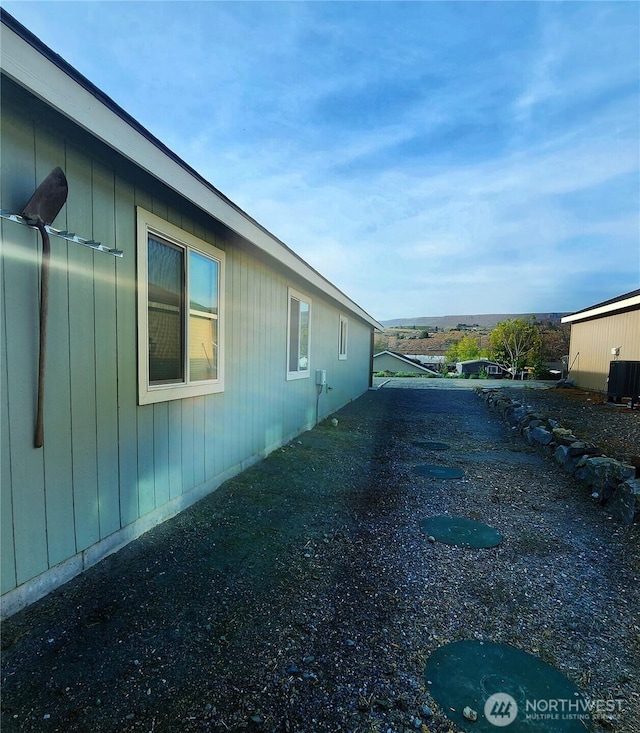 view of side of home featuring central AC