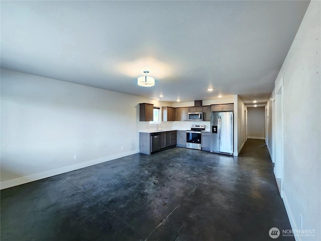 unfurnished living room featuring baseboards, recessed lighting, concrete floors, and a sink