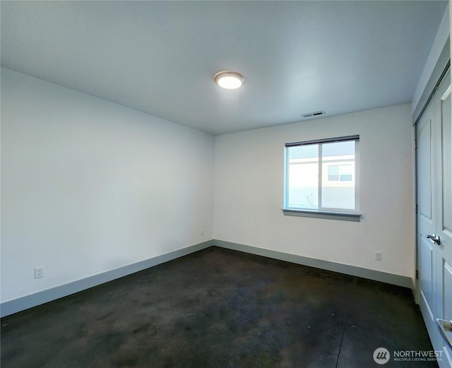 unfurnished bedroom featuring concrete floors, visible vents, a closet, and baseboards