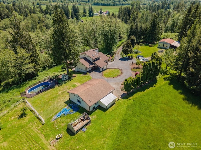 birds eye view of property with a view of trees