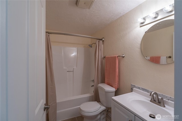 bathroom featuring a textured ceiling, vanity, toilet, shower / tub combo with curtain, and a textured wall
