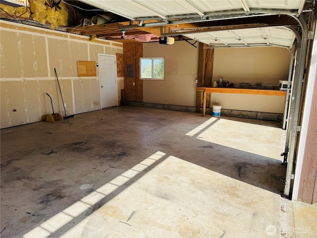 garage featuring a garage door opener and electric panel