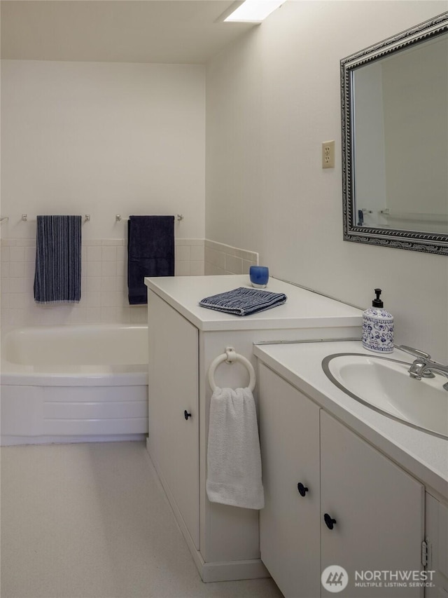 full bath featuring a bath and vanity