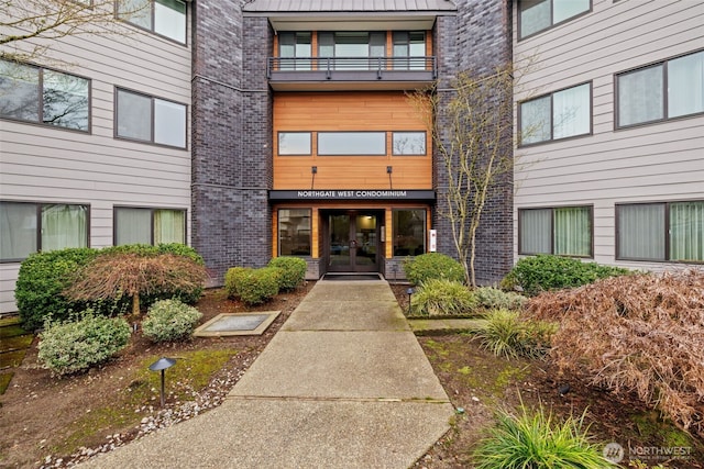property entrance with brick siding and french doors