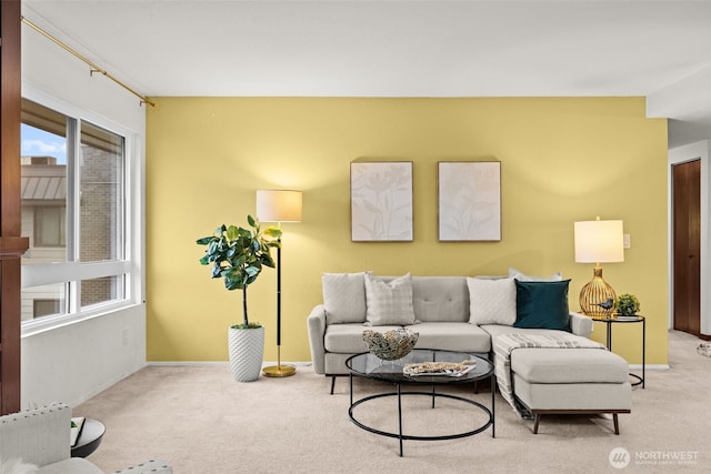 carpeted living room with baseboards