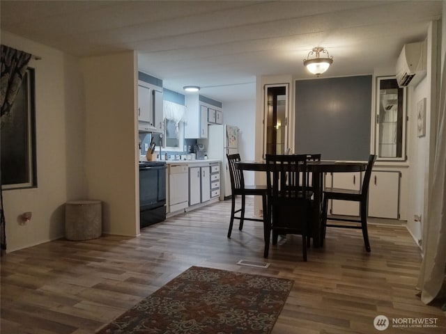 302 Pioneer Rd, Aberdeen, WA 98520 - dining space with an AC wall unit and wood finished floors