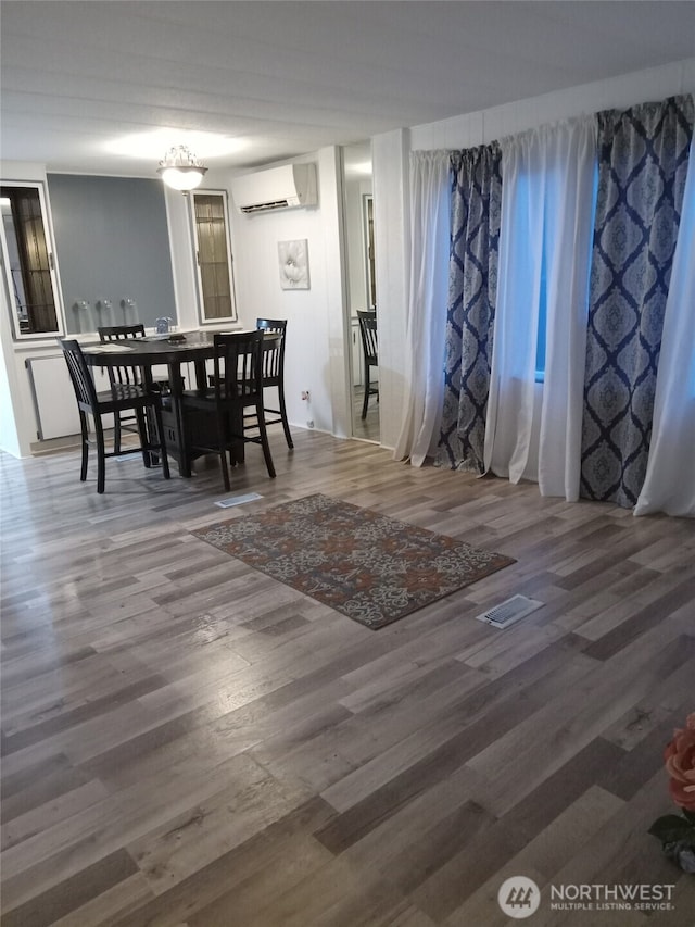 302 Pioneer Rd, Aberdeen, WA 98520 - dining room with a wall mounted AC and wood finished floors