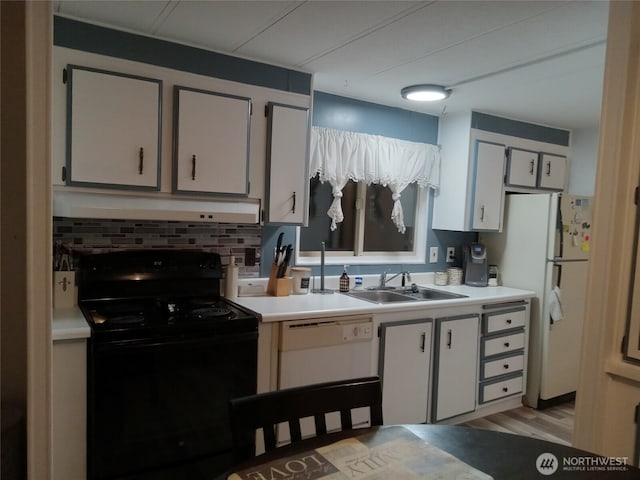 302 Pioneer Rd, Aberdeen, WA 98520 - kitchen featuring white appliances, under cabinet range hood, light countertops, decorative backsplash, and light wood finished floors