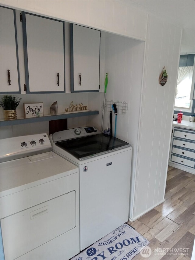 302 Pioneer Rd, Aberdeen, WA 98520 - laundry area with cabinet space, washer and dryer, and light wood-type flooring