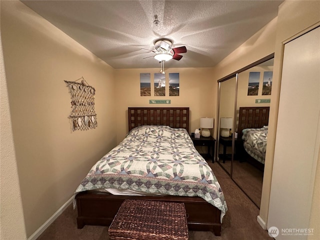 bedroom featuring a closet, a textured ceiling, carpet, baseboards, and ceiling fan