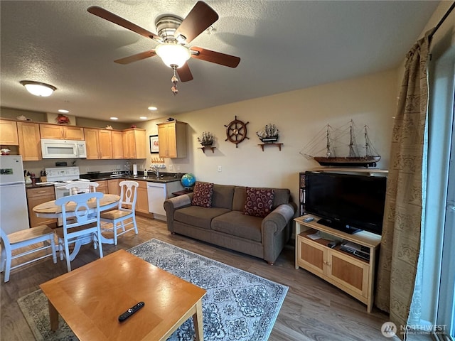 living room with recessed lighting, a textured ceiling, ceiling fan, and wood finished floors