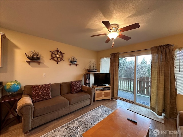 living room with ceiling fan and wood finished floors