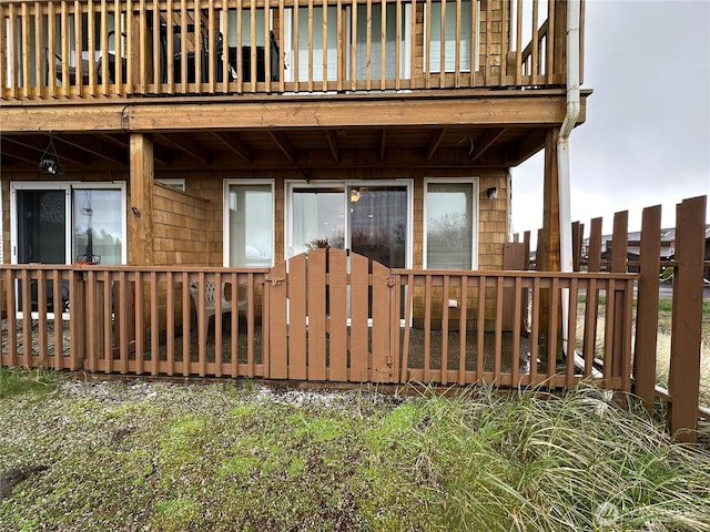 view of exterior entry with a balcony
