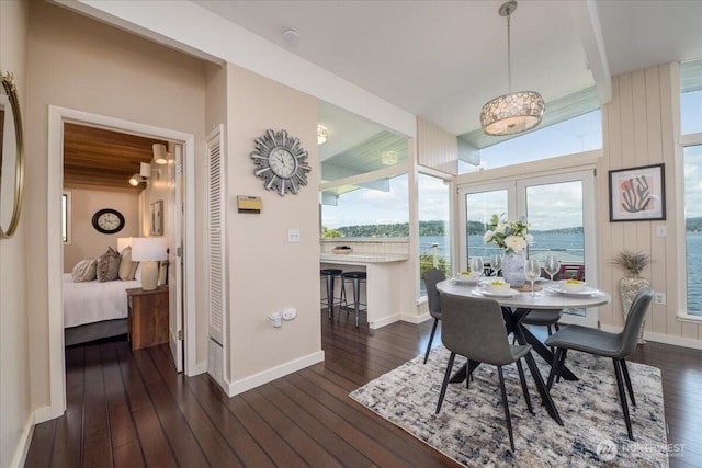 dining space featuring baseboards and dark wood-style floors