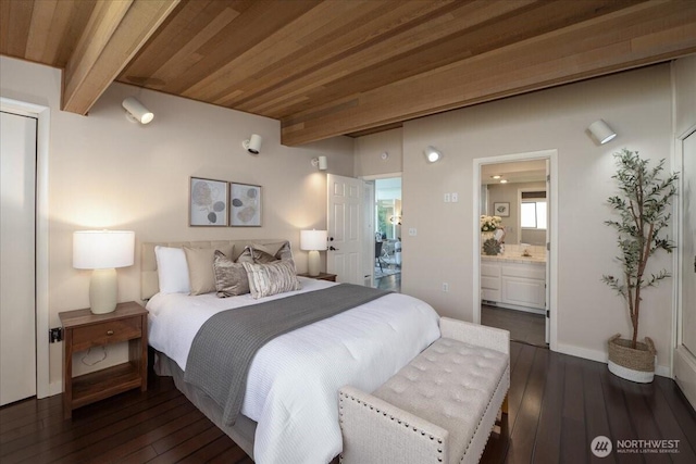 bedroom featuring dark wood-style flooring, beamed ceiling, wood ceiling, and ensuite bathroom