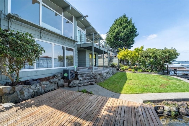 back of house featuring a yard, a deck, and cooling unit