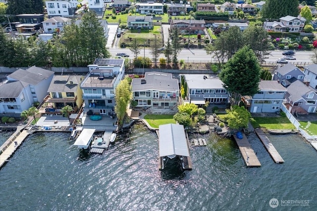 bird's eye view featuring a water view and a residential view