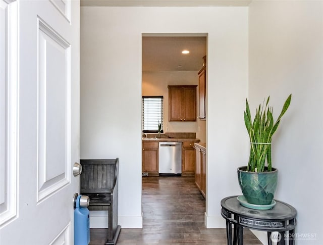 corridor featuring a sink, dark wood-style floors, and recessed lighting