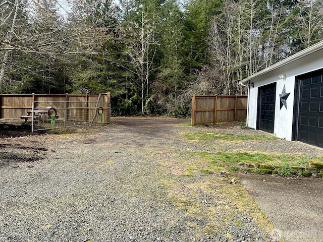 view of yard with fence and a garage