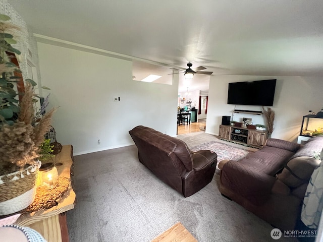 living room featuring carpet and a ceiling fan