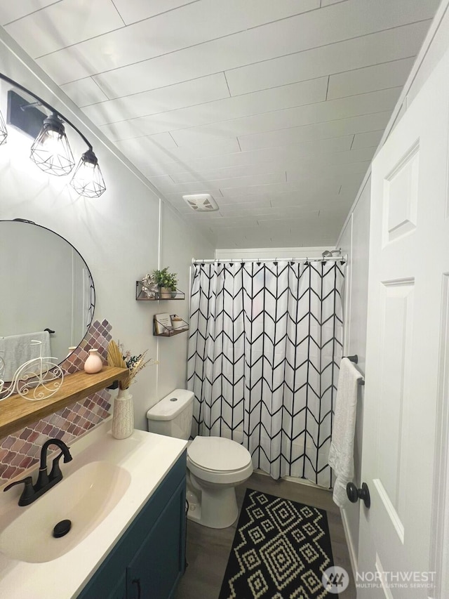 bathroom with vanity, toilet, and a shower with curtain