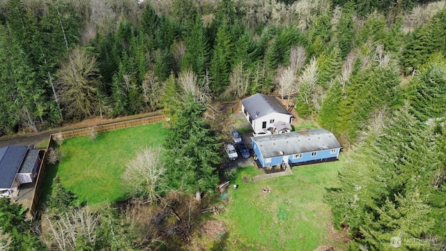 birds eye view of property featuring a wooded view