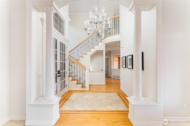 15832 SE 45th St, Bellevue, WA 98006 - entryway with stairway, a high ceiling, wood finished floors, decorative columns, and a notable chandelier