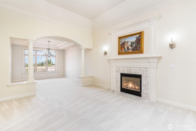 15832 SE 45th St, Bellevue, WA 98006 - unfurnished living room with carpet, an inviting chandelier, a tiled fireplace, baseboards, and ornate columns