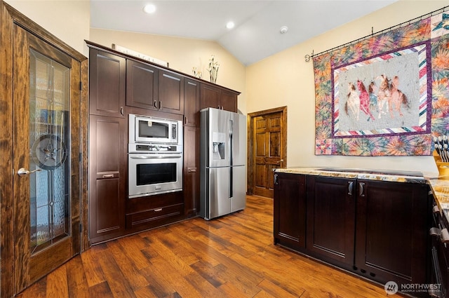 3609 Lakeshore Dr, Moses Lake, WA 98837 - kitchen with appliances with stainless steel finishes, lofted ceiling, dark brown cabinets, and dark wood-style flooring