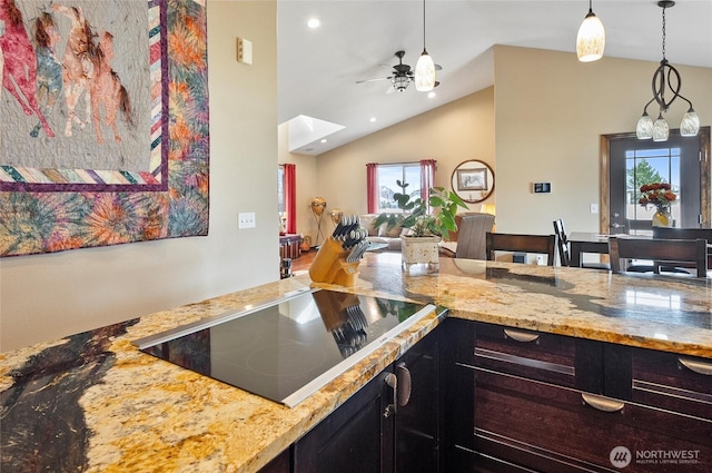 3609 Lakeshore Dr, Moses Lake, WA 98837 - kitchen with black electric stovetop, a ceiling fan, lofted ceiling, a skylight, and light stone countertops