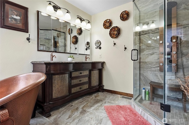 3609 Lakeshore Dr, Moses Lake, WA 98837 - bathroom with double vanity, marble finish floors, a shower stall, a freestanding tub, and baseboards
