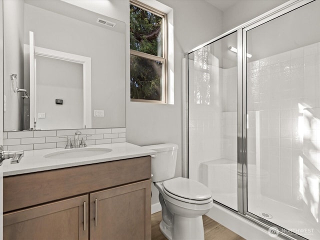11521 SE 236th St, Kent, WA 98031 - bathroom featuring a stall shower, vanity, toilet, and tasteful backsplash