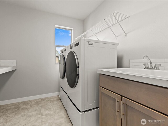 11521 SE 236th St, Kent, WA 98031 - clothes washing area featuring washing machine and clothes dryer, cabinet space, and baseboards