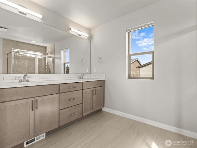 11521 SE 236th St, Kent, WA 98031 - bathroom featuring a shower stall, double vanity, and baseboards