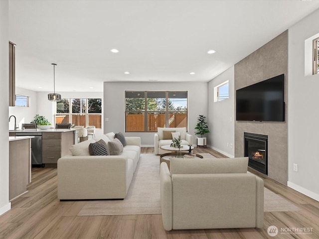 11521 SE 236th St, Kent, WA 98031 - living area featuring a fireplace, light wood-type flooring, recessed lighting, and baseboards