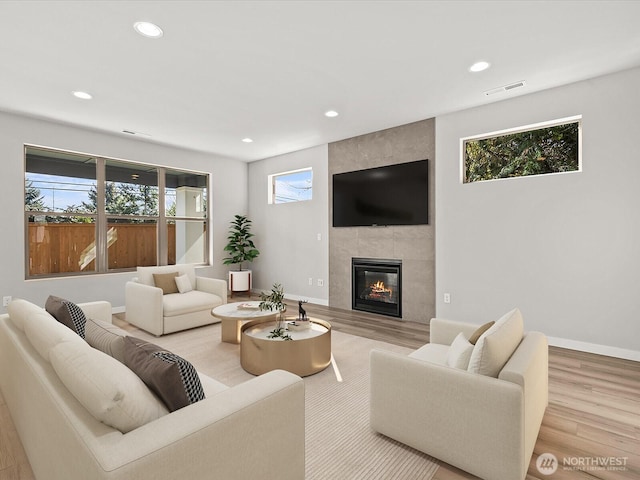 11521 SE 236th St, Kent, WA 98031 - living room with recessed lighting, light wood-type flooring, a tile fireplace, and baseboards