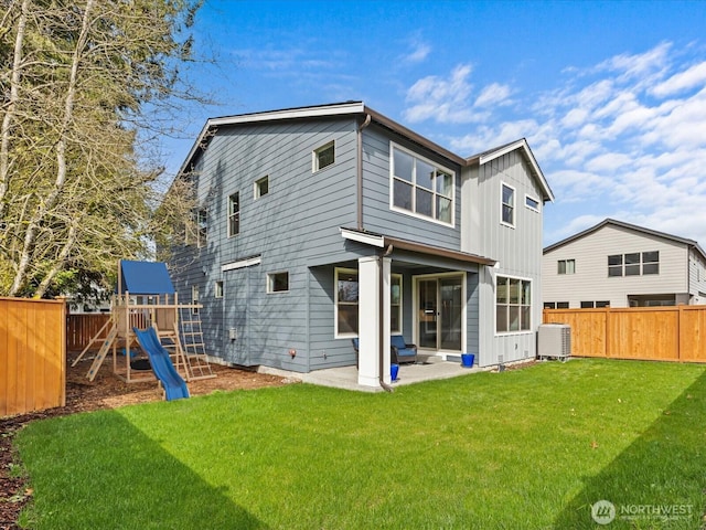11521 SE 236th St, Kent, WA 98031 - back of house with a playground, central AC unit, board and batten siding, and a patio