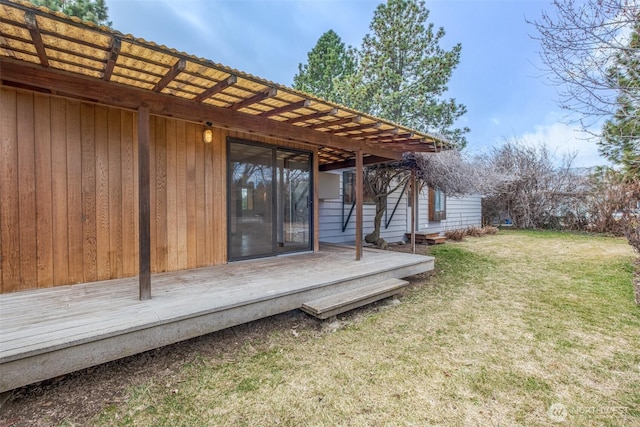 wooden terrace featuring a yard