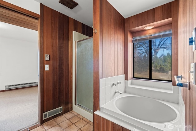bathroom with baseboard heating, a shower stall, wooden walls, visible vents, and a bath