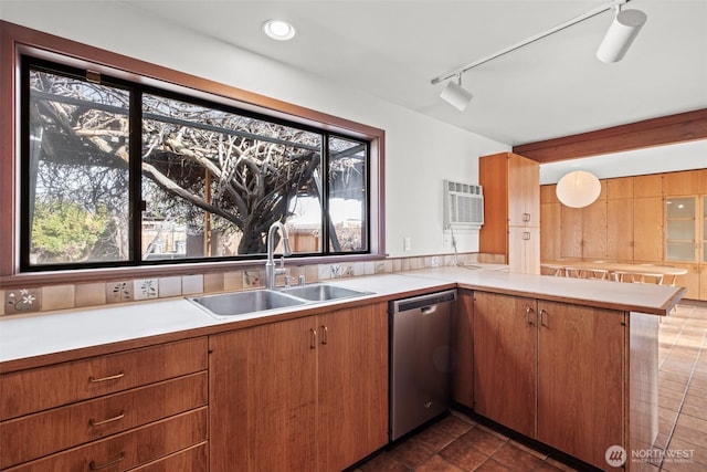kitchen with plenty of natural light, a sink, light countertops, and dishwasher