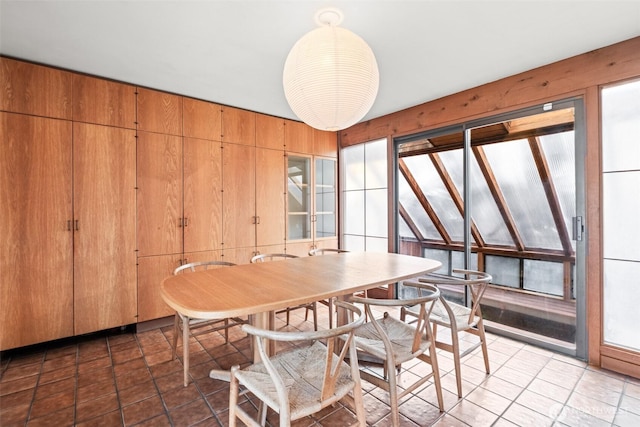 tiled dining space with wooden walls