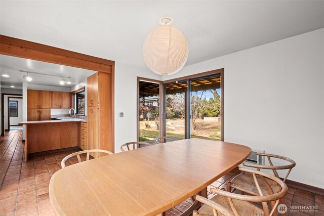 dining area featuring baseboards