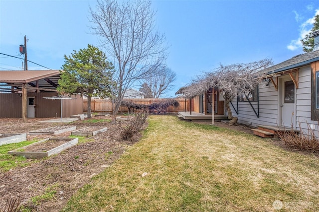 view of yard featuring a vegetable garden and fence